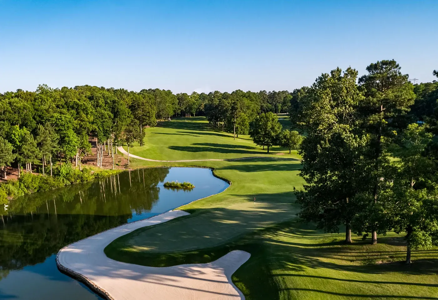 Golf course green beside a lake